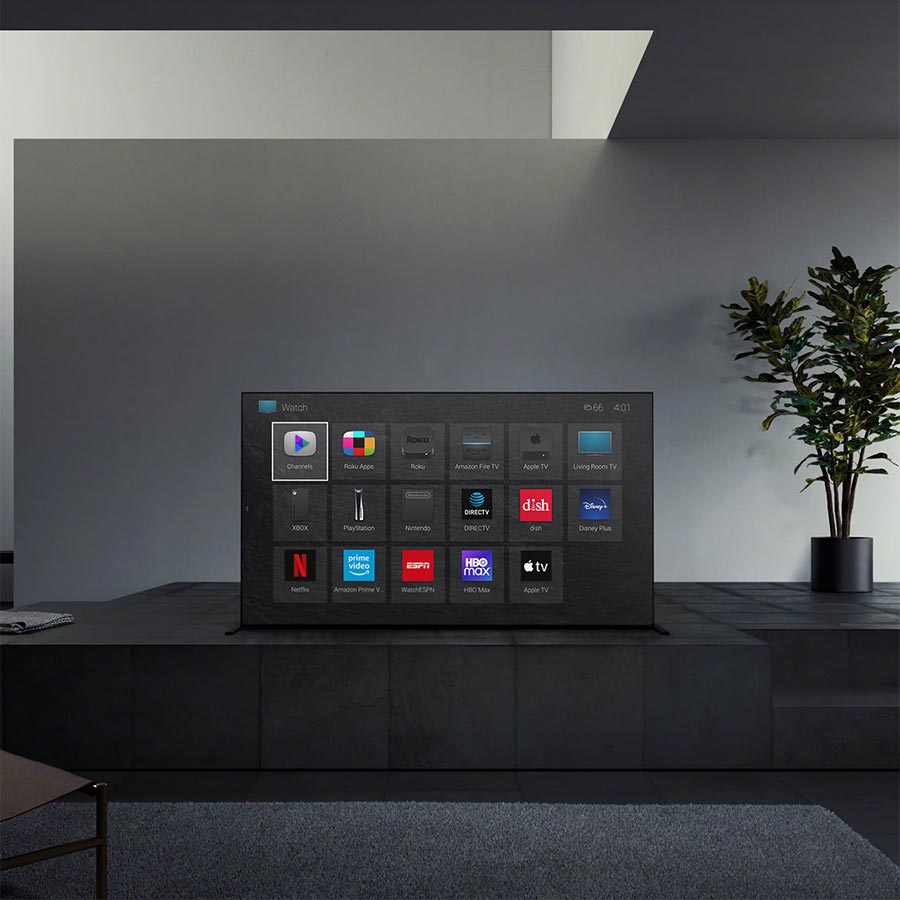 Sleek black entertainment setup featuring a smart TV interface in a dark room