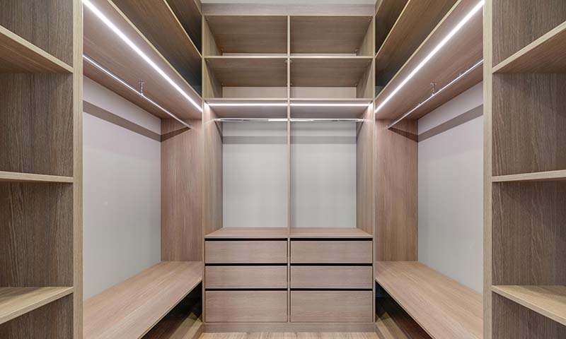 An empty closet with linear LED lighting