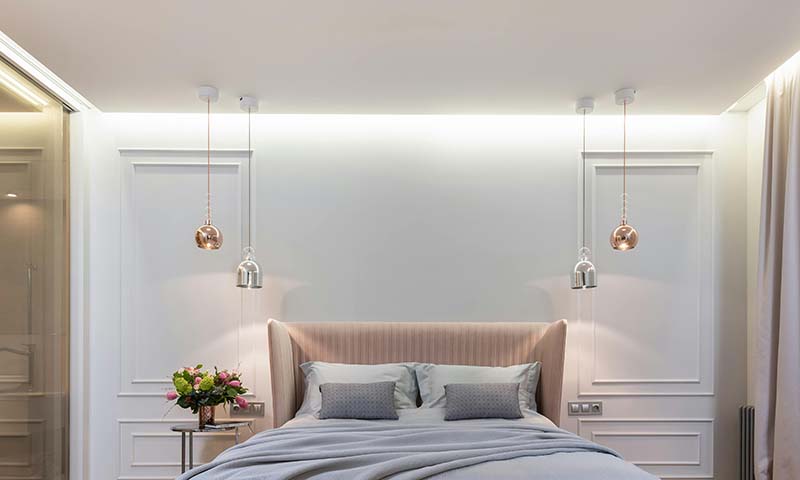 a white bedroom with pink accents