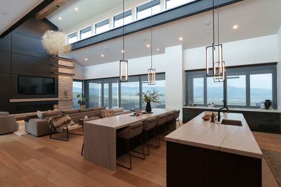 A living area with beautiful lighting, in-ceiling speakers, flat panel TV, and expansive views.