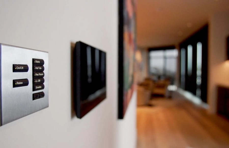 A smart home control panel mounted onto the wall of a home.