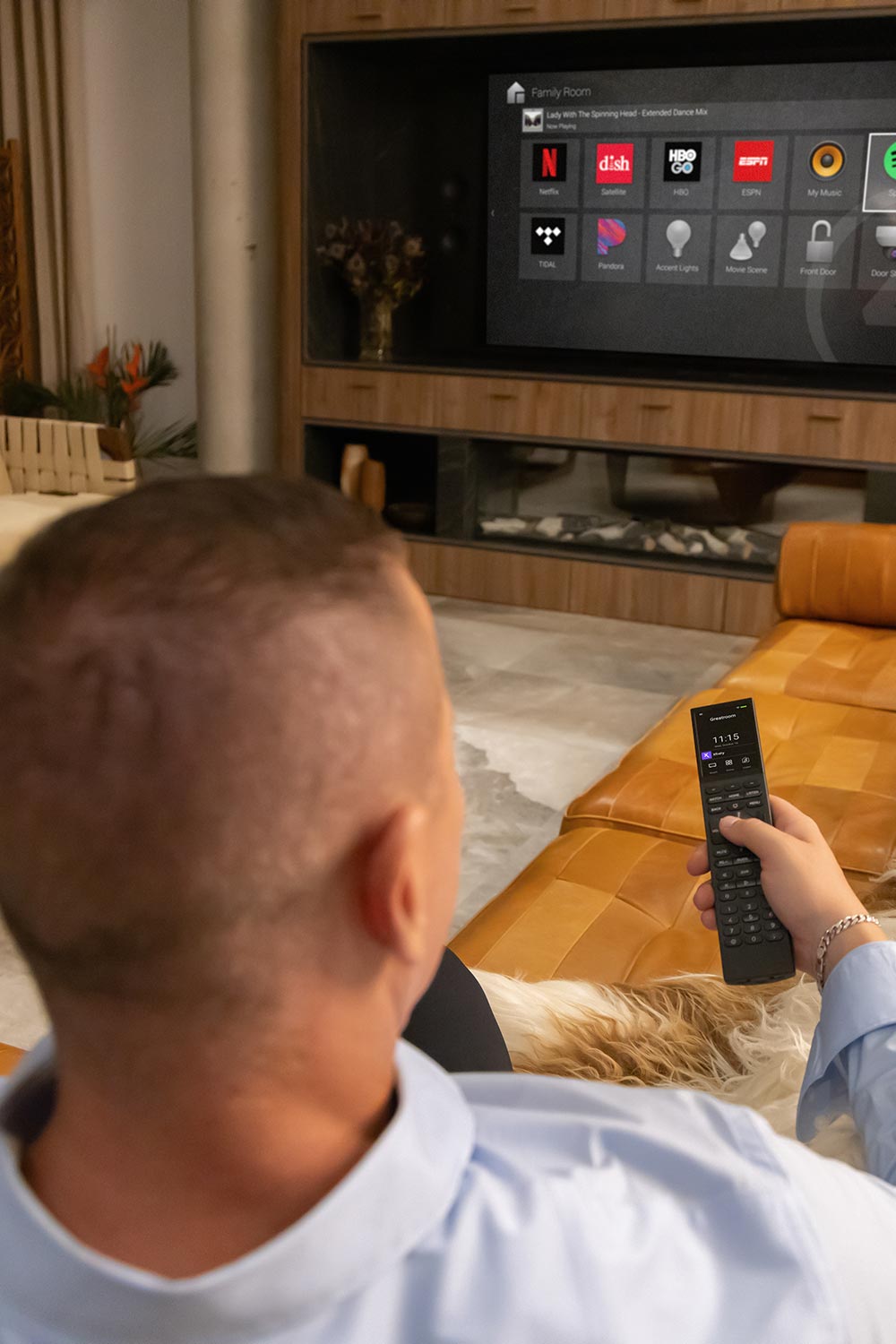 Man using a remote control to operate a smart TV interface