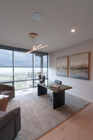 Modern home office with in-ceiling speakers and Lutron smart lighting technology