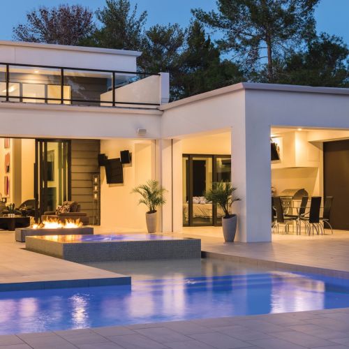 Smart home keypad with six preset buttons. A bedroom is in the background.