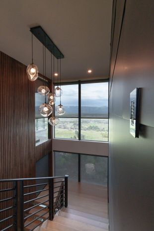 Modern house staircase with Lutron Lighting control keypad and modern glass lighting fixtures