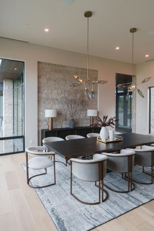 Dining room with in-ceiling speakers and modern lighting fixtures