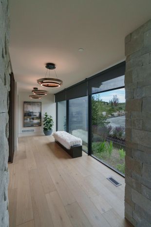 Modern house hallway with circular lighting fixtures and in-ceiling speakers
