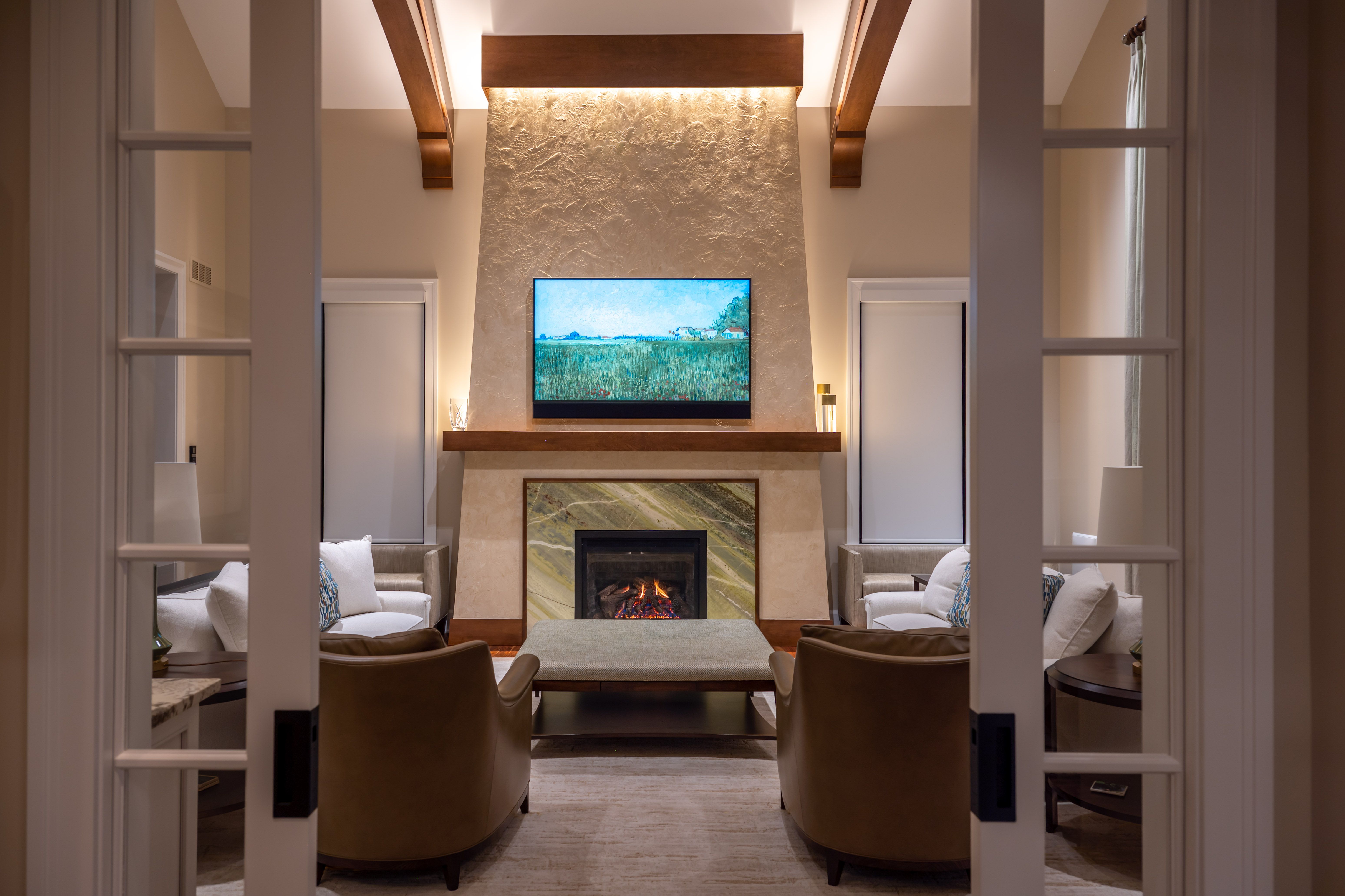 A living room with vaulted ceilings, a central fireplace, and comfortable seating.