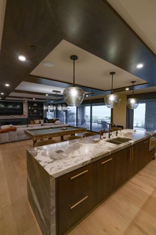 Modern dark and light wood game room with Lutron lighting and in-ceiling speakers