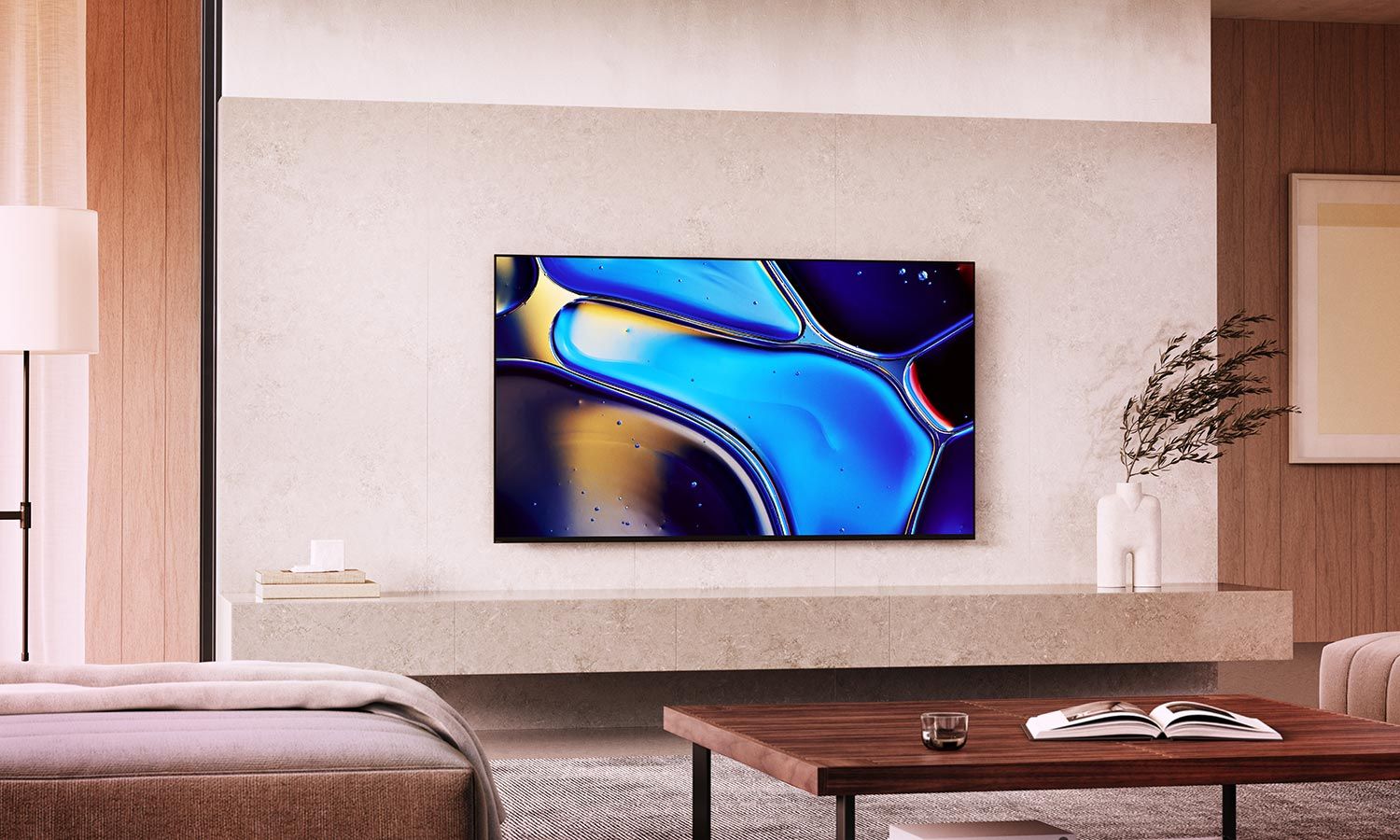 A flat-screen TV mounted on a light-colored wall, displaying a colorful abstract image in a stylish living room with a minimalist design.