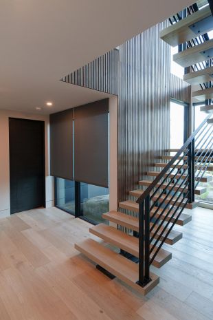 Modern house staircase with hidden Lutron Palladiom Shades